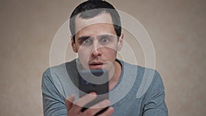 Surprised man looking at mobile phone