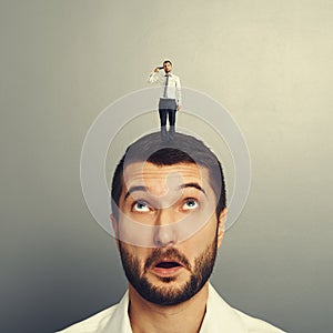 Surprised man looking at small man