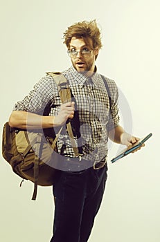 Surprised man with open mouth, backpack and notebook