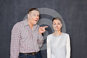 Surprised man is pointing at funny stupid woman