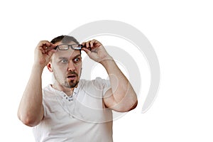 Surprised man, shocked with bulging eyes, glasses climbed over his forehead, isolated on white background