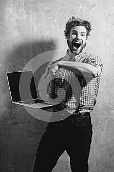 Surprised man or student with open mouth and laptop