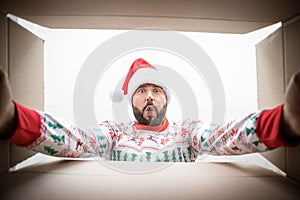 Surprised man unpack Christmas gift box