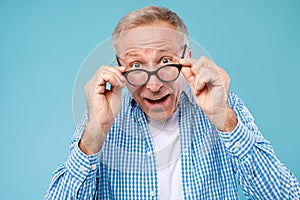 Surprised mature man in glasses staring at camera