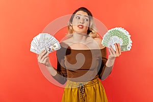 Surprised mercantile woman holding fans of dollar and euro banknotes, currency exchange rates, payment service