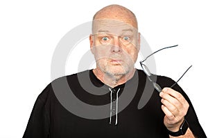 Surprised Middle-Aged Caucasian Man Holding Dark Eyeglasses Frame on White Background - Shocked Expression