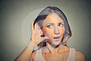 Surprised nosy woman hand to ear gesture carefully secretly listening photo