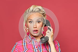 Surprised pinup woman phone on red background