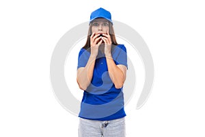 surprised pretty young caucasian brunette advertiser woman in blank blue t-shirt and cap for print illustration