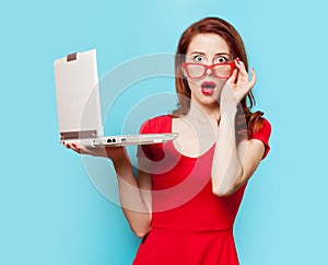 Surprised redhead girl with laptop