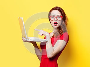 Surprised redhead girl with laptop