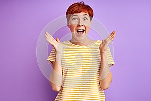 Surprised redhead woman is emotionally reacts on something