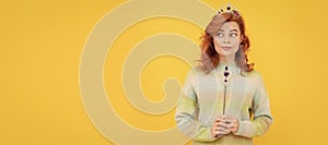 surprised redhead woman in queen crown with magic wand, magic. Woman isolated face portrait, banner with copy space.