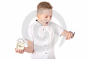 Surprised schoolboy with alarm clock and wach, isolated on white