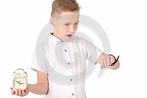 Surprised schoolboy with alarm clock and wach, isolated on white