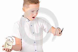 Surprised schoolboy with alarm clock and wach, isolated on white