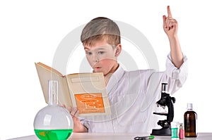 Surprised scientist boy find solution in his book