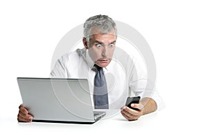 Surprised senior businessman gesture mobile phone