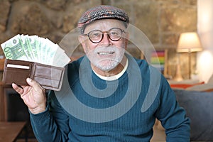 Surprised senior man with full wallet