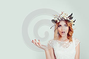 Surprised stunned woman in floral headband portrait