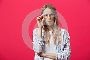 Surprised teenage student girl show shocking expression with something. Isolated on Bright Pink Background. Copy space