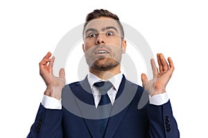 surprised unshaved man looking up and shockingly gesturing