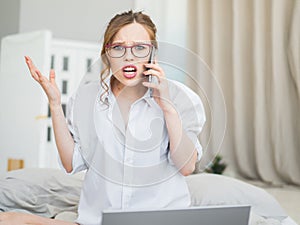 Surprised woman, astonished woman with shocked face and open mouth holding phone. Scream