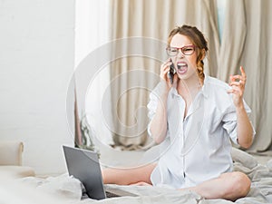 Surprised woman, astonished woman with shocked face and open mouth holding phone. Scream
