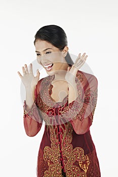 Surprised woman in baju kebaya with hands opened. Conceptual image