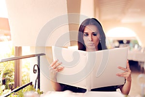 Surprised Woman Choosing from Restaurant Menu