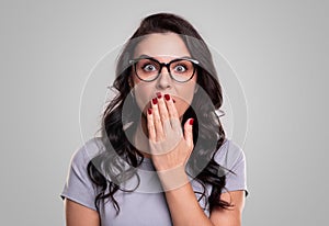 Surprised woman covering mouth with hand