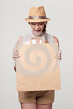Surprised woman with craft shopping bag