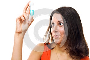 Surprised woman examine test tube