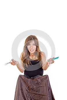 Surprised woman hairdresser with comb and scissors waiting