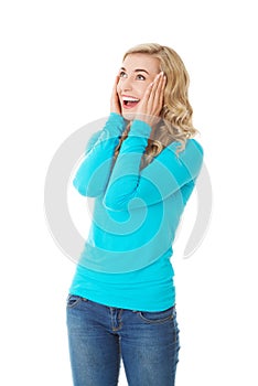 Surprised woman with hands on head