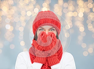 Surprised woman in hat, scarf and mittens