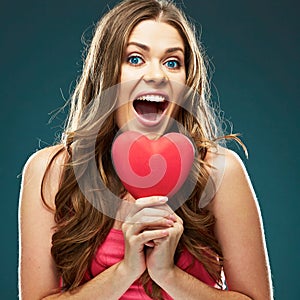 Surprised woman hold red heart