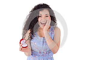 Surprised woman holding an open jewelery gift box.