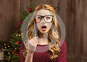 Surprised woman holding party glasses