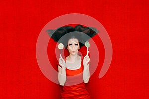 Surprised Woman With Lollipops on Red Background