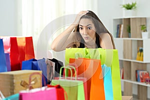 Surprised woman looking at multiple purchases photo