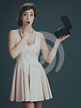 Surprised woman opening gift