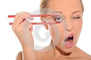 Surprised woman opens her eyes chopsticks