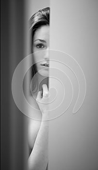 Surprised Woman Peeking Out of Bathroom Door