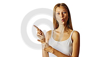 Surprised woman pointing to the left with forefinger