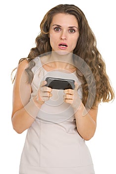 Surprised woman reading sms