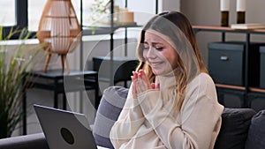 Surprised Woman Receiving Good News In Laptop And Exclaiming Wow At Home