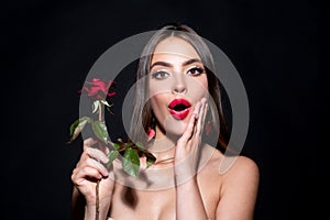 Surprised woman with red lips and rose flower. Fashion beauty portrait on studio background.