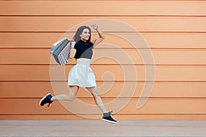 Surprised Woman Running With Shopping Bags in Summer Sale Season