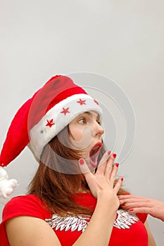 Surprised woman in Santa hat